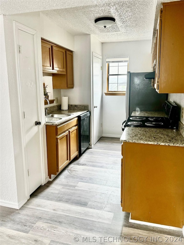 kitchen with a textured ceiling, sink, and black appliances