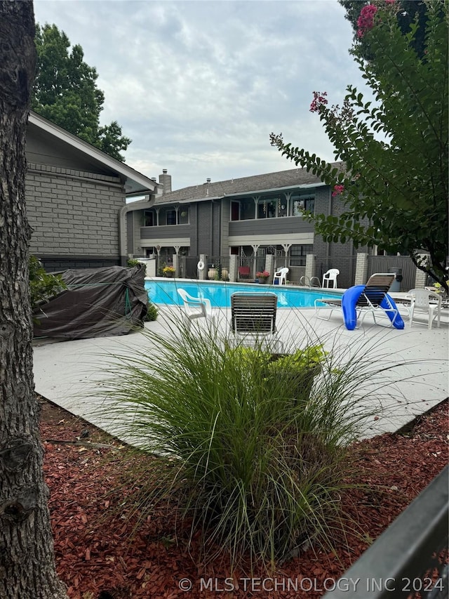 view of swimming pool with a patio area