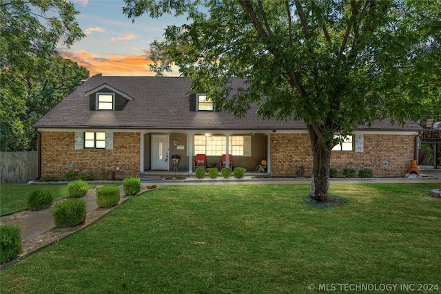 new england style home with a yard