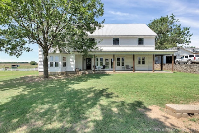 back of property featuring a lawn