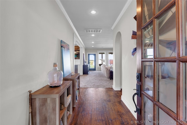 hallway featuring dark carpet and ornamental molding