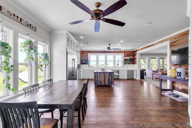 dining space with ornamental molding, ceiling fan, and dark wood-type flooring