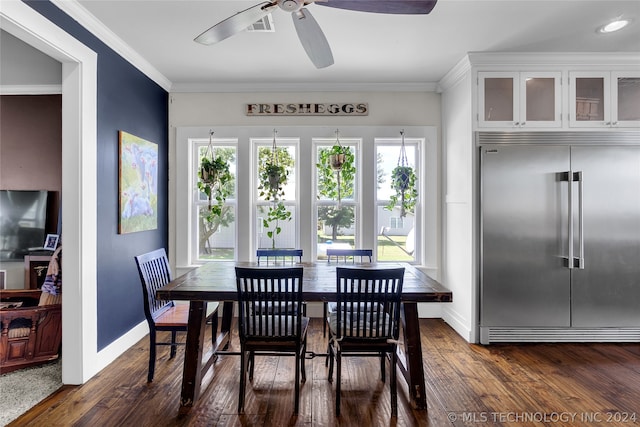 dining room featuring wood-type flooring, crown molding, and ceiling fan