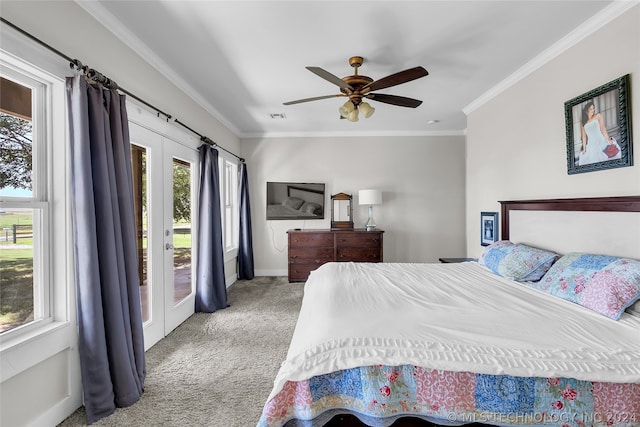 bedroom with access to exterior, multiple windows, ceiling fan, and light colored carpet