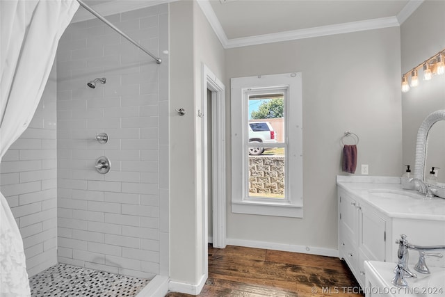 bathroom with vanity, hardwood / wood-style flooring, a shower with shower curtain, and crown molding