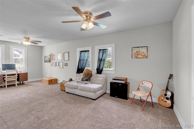 carpeted living room featuring ceiling fan