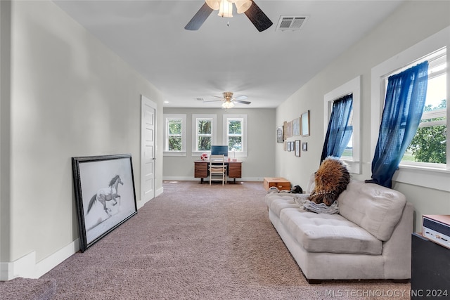 carpeted living room featuring ceiling fan