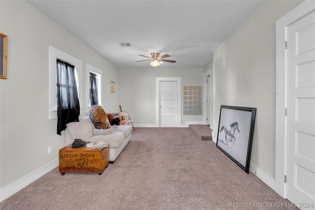 living room featuring carpet and ceiling fan