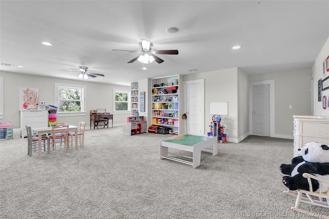 rec room featuring light carpet and ceiling fan