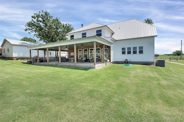 back of property featuring central AC, a patio area, a lawn, and ceiling fan