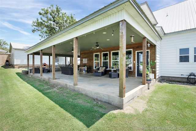 rear view of house with a patio area, a yard, outdoor lounge area, and ceiling fan