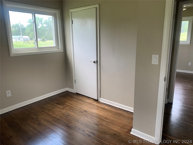 unfurnished bedroom featuring dark wood-type flooring