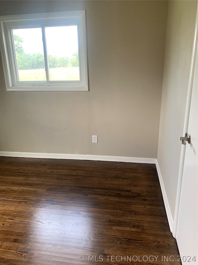 empty room featuring dark hardwood / wood-style flooring