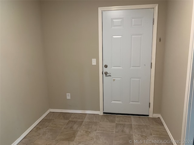 entryway with light tile patterned flooring