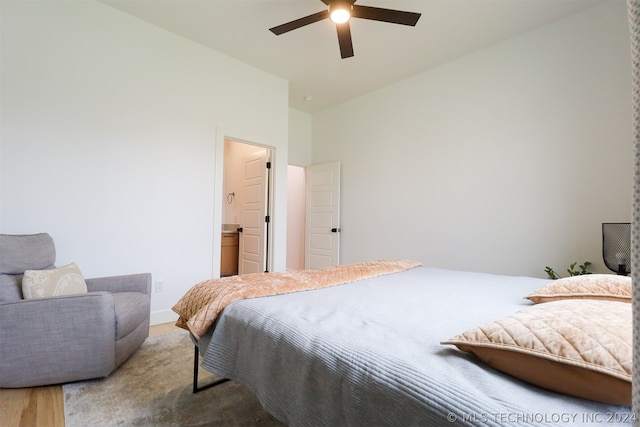 bedroom featuring connected bathroom, vaulted ceiling, and ceiling fan