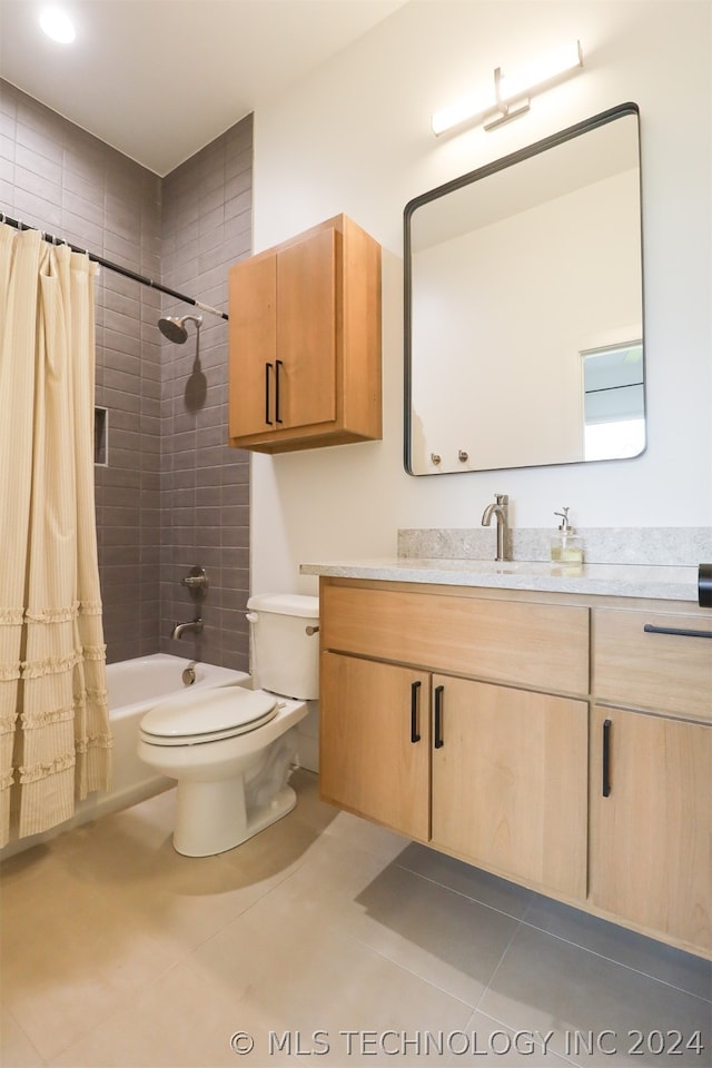 full bathroom with tile patterned flooring, shower / bath combo with shower curtain, toilet, and vanity