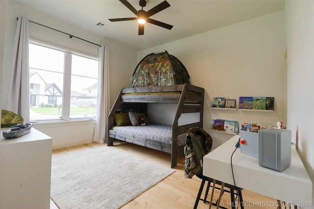 bedroom with ceiling fan and light wood-type flooring