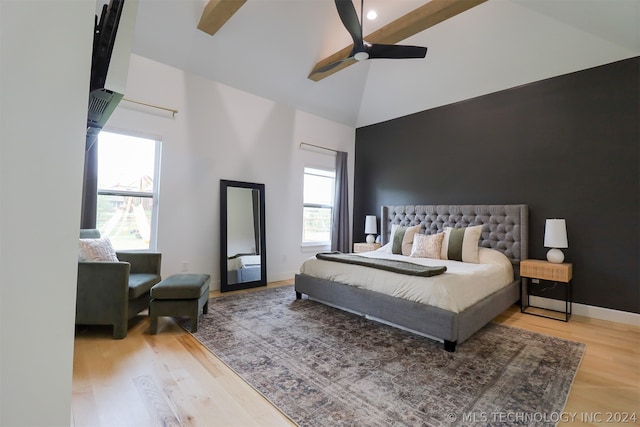 bedroom featuring light hardwood / wood-style floors, beamed ceiling, ceiling fan, and high vaulted ceiling