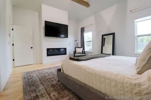 bedroom with light hardwood / wood-style floors and ceiling fan