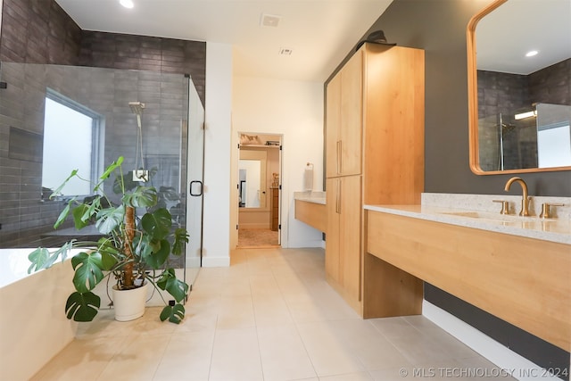 bathroom with vanity, an enclosed shower, and tile patterned floors