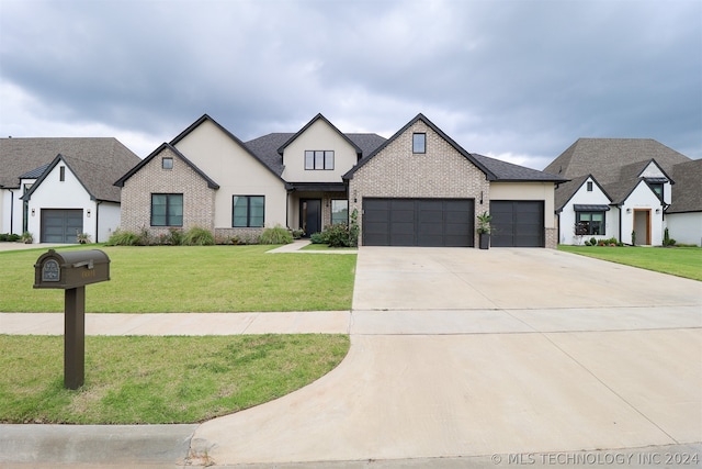 view of front of home with a garage and a front lawn