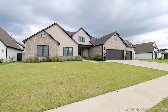 view of front of house featuring a garage and a front lawn