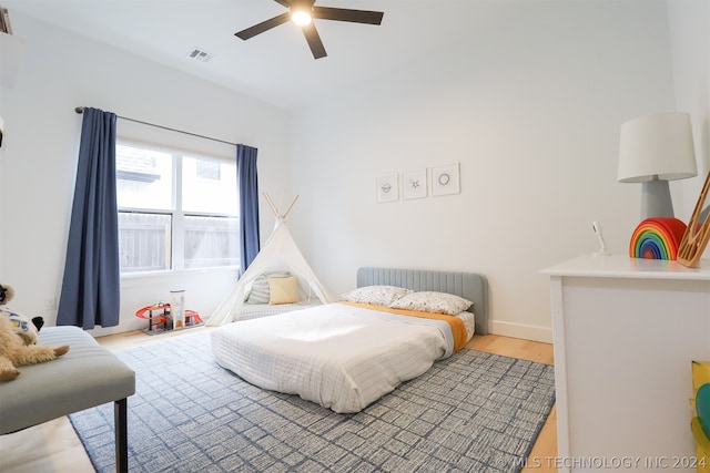 bedroom with light wood-type flooring and ceiling fan