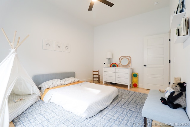 bedroom with light hardwood / wood-style flooring and ceiling fan