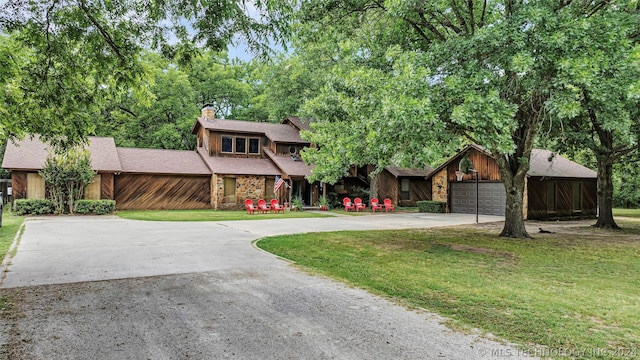 view of front of house with a garage and a front lawn