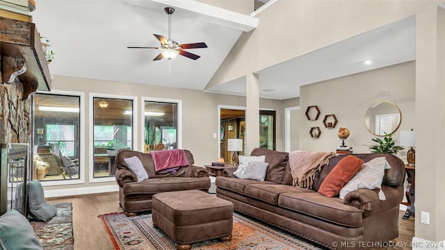 living room with dark hardwood / wood-style floors, high vaulted ceiling, and ceiling fan