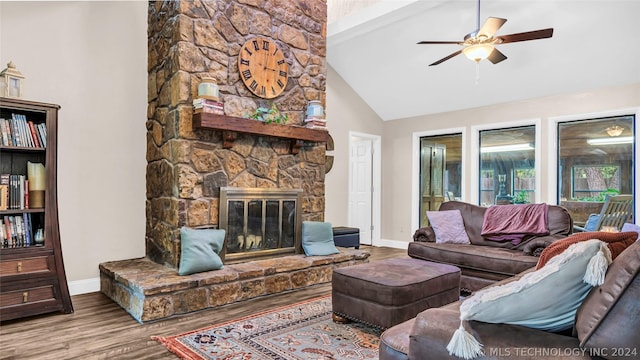 living room with a fireplace, light wood-type flooring, beam ceiling, and ceiling fan