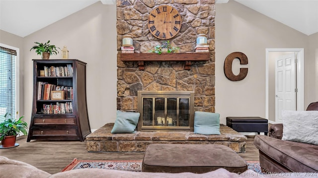 living room with hardwood / wood-style floors, a fireplace, and lofted ceiling