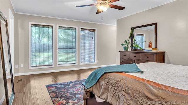 bedroom featuring ceiling fan, hardwood / wood-style floors, and ornamental molding