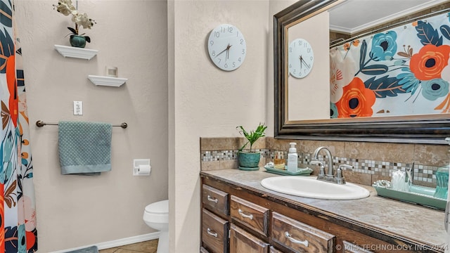 bathroom with toilet, tasteful backsplash, tile patterned floors, and vanity