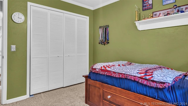 bedroom with a closet, light colored carpet, and ornamental molding