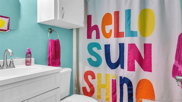 bathroom featuring toilet and vanity