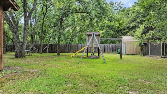 view of yard featuring a playground and a storage unit