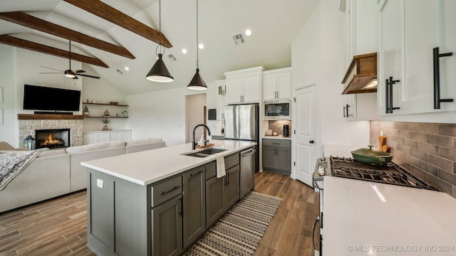 kitchen featuring stainless steel appliances, a center island with sink, sink, gray cabinets, and white cabinets