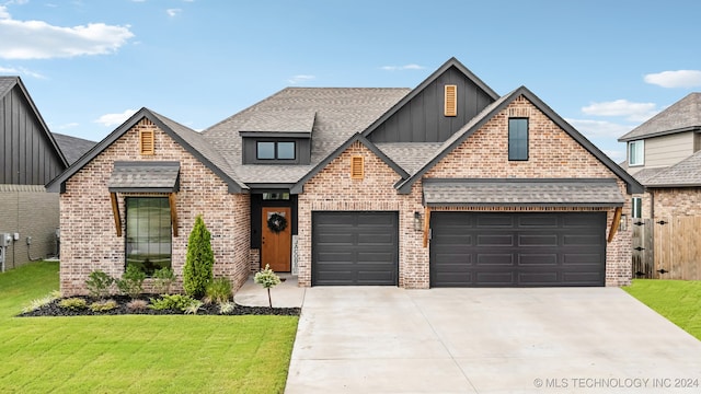 view of front of property with a front yard and a garage