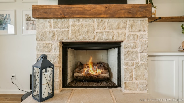 interior details featuring a stone fireplace