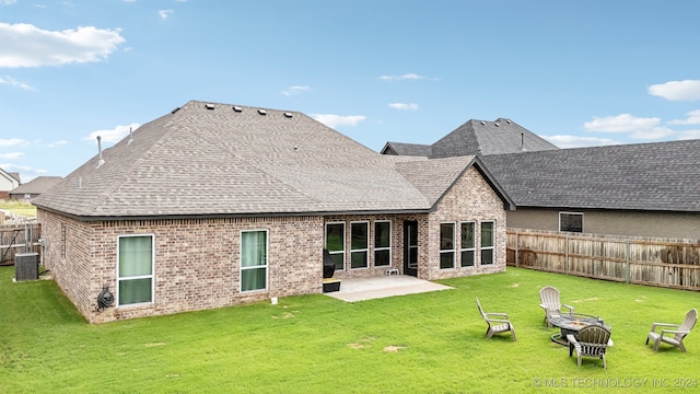 rear view of property featuring a patio area, a yard, and cooling unit