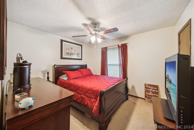 bedroom with light carpet, a textured ceiling, and ceiling fan