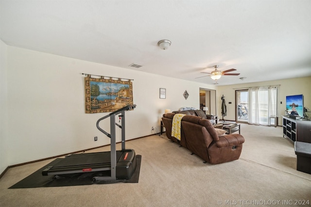 carpeted living room with ceiling fan