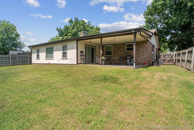 back of house with a patio, central AC unit, and a lawn