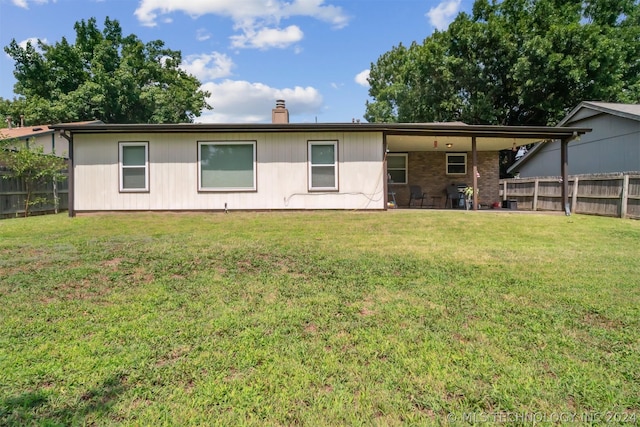 back of property featuring a lawn