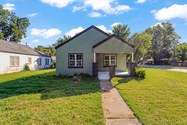 bungalow-style home with a front lawn