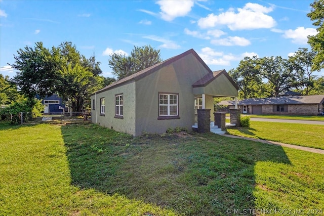 view of side of property with a yard