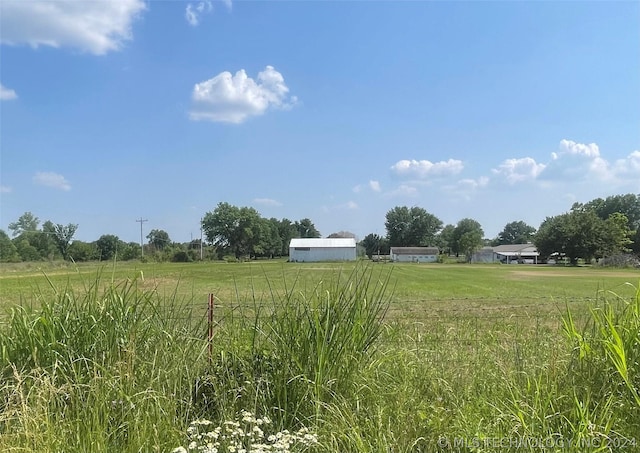 view of yard with a rural view