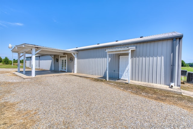 back of property with a carport