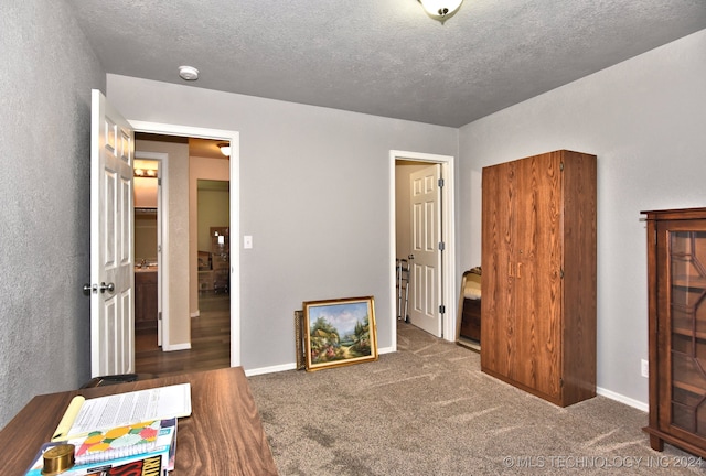 carpeted bedroom with a textured ceiling